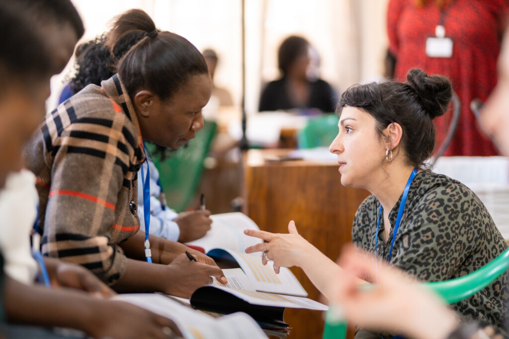 Image depicts two workshop participants talking