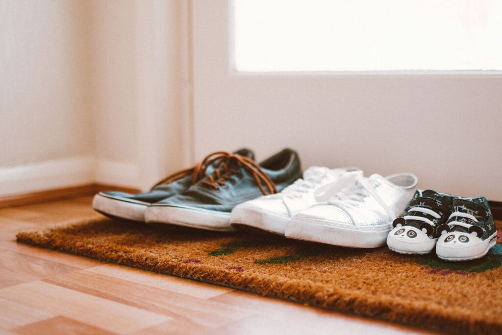 What happens to the family home after divorce? Image of family shoes by the front door.